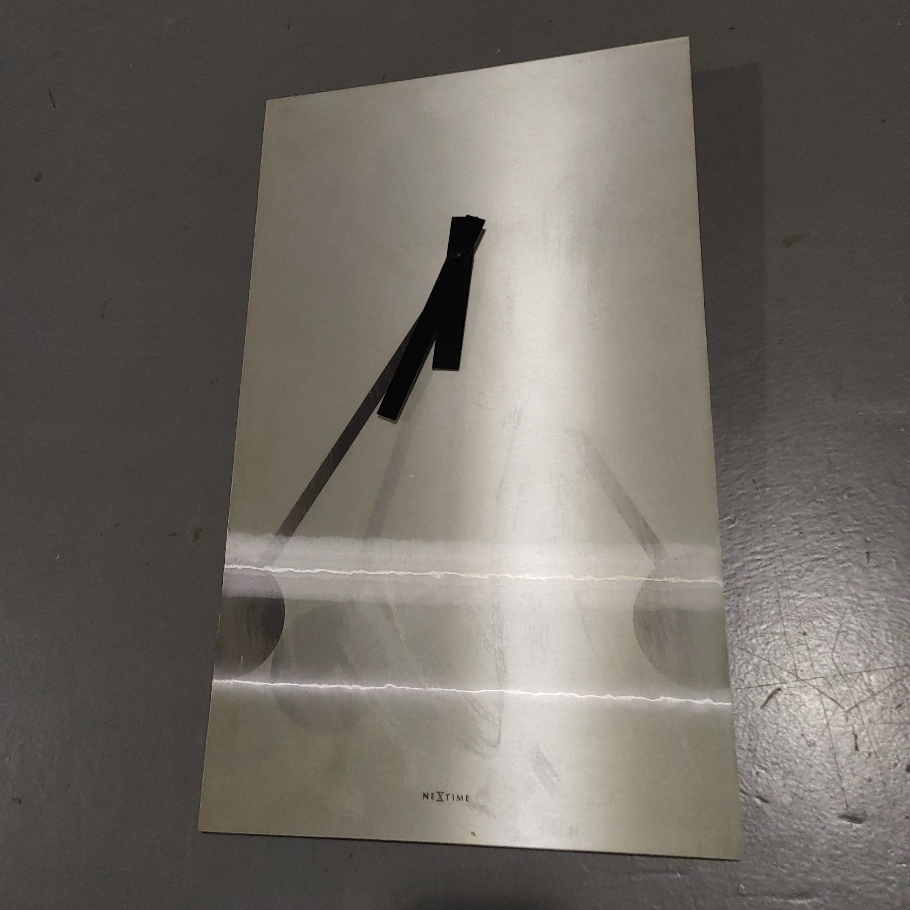 Wall clock with optical moving pendulum