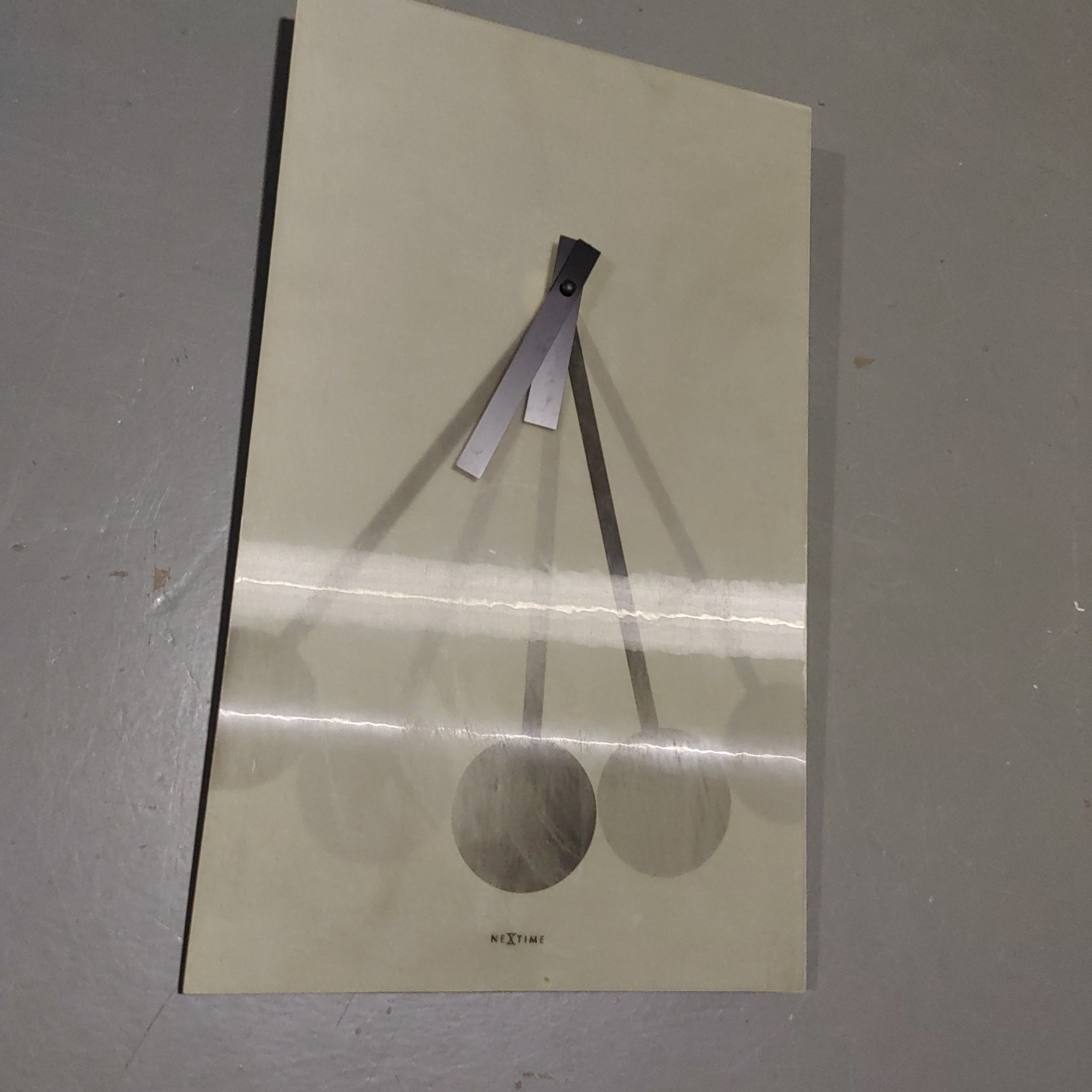 Wall clock with optical moving pendulum